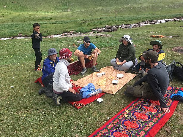 Evan Miles, Stefan Fugger and Pascal Buri were offered locally-made yogurt and bread by kids (9) before being challenged to a football match. Photo: A. Jouberton